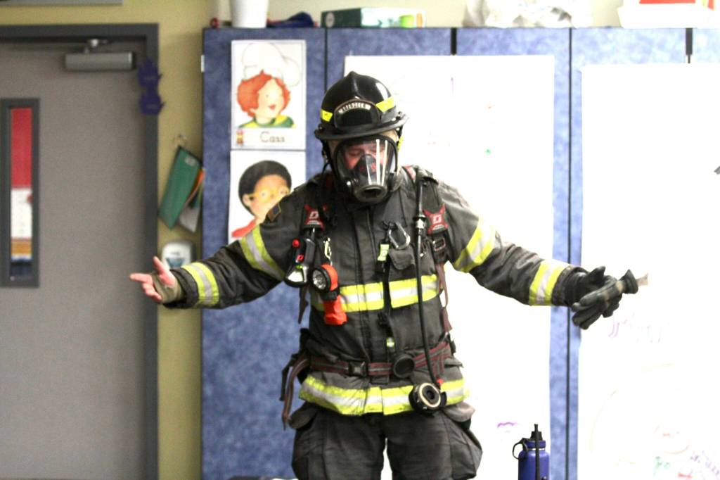 Aberdeen firefighter Kolby Lyle demonstrates his protective gear to kindergarten students at Robert Gray Elementary on Oct. 10 as part of Fire Prevention Week. (Michael S. Lockett / The Daily World)