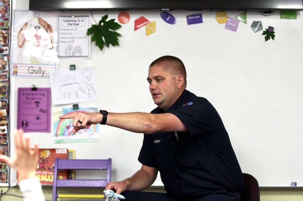 Michael S. Lockett / The Daily World
Aberdeen fire services specialist Mitch Housden points to a kindergarten student to answer his question at Robert Gray Elementary on Oct. 10 as part of Fire Prevention Week.
