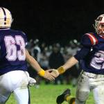 RYAN SPARKS | THE DAILY WORLD Pe Ell-Willapa Valley defensive back Cody Mican (22) gets a low-five from teammate Hank Swartz during the Titans 14-12 win over Raymond-South Bend on Friday in Menlo.