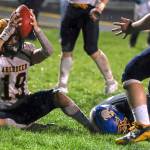 THE CHRONICLE Aberdeenss Aiden Watkins holds the ball up after scoring a toucdown during a 20-8 win over Rochester on Friday in Rochester.