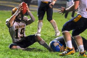 THE CHRONICLE Aberdeenss Aiden Watkins holds the ball up after scoring a toucdown during a 20-8 win over Rochester on Friday in Rochester.