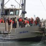 Members of the Marine Resource Committee go out to see crews collecting European green crab near Westport on Oct. 13, 2023. (Michael S. Lockett / The Daily World)