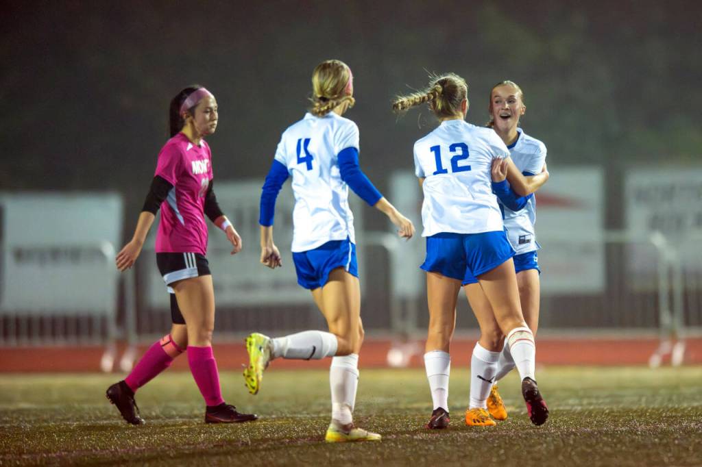 PHOTO BY FOREST WORGUM Elma midfielder Miley Seaberg, right, in congratulated by Beta Valentine (12) and Aaleigha Weld (4) while Montesanos Bethanie Henderson looks on after scoring a goal in the first half of a 1-0 win Thursday in Montesano.