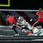 PHOTO BY FOREST WORGUM 
Montesano linebacker Gaby Pyhala (11) wrangles Tenino quarterback Cody Strawn (3) during the Bulldogs 42-0 win on Friday at Tenino High School.