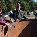 Clayton Franke / The Daily World
Kelpie Wilson, left, talks about her biochar kiln during a demonstration at the Ocean Shores public works yard on Oct. 18. Wilson has sold more than 250 of the steel kilns, which are a tool for producing biochar  burned remnants of organic matter especially effective at reducing carbon emissions in soil.