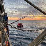(U.S. Coast Guard Pacific Northwest) A good Samaritan vessel on Thursday, Oct. 26 approaches a life raft holding one of the two crew members from the missing fishing vessel Evening, found alive nearly two weeks after the boat was scheduled to return to Grays Harbor. The other crew member remains missing.