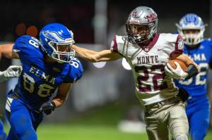 PHOTO BY FOREST WORGUM Montesanos Bode Poler (22) carries the ball while Elmas Traden Carter (88) defends during the Bulldogs 49-0 win on Friday at Davis Field in Elma.