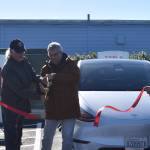 Clayton Franke / The Daily World
From left: Tesla owner Darrel Prowse, Ocean Shores Mayor Jon Martin and Fire Chief Brian Ritter cut the ceremonial ribbon for the Tesla Supercharger station in Ocean Shores on Saturday, Oct. 28.