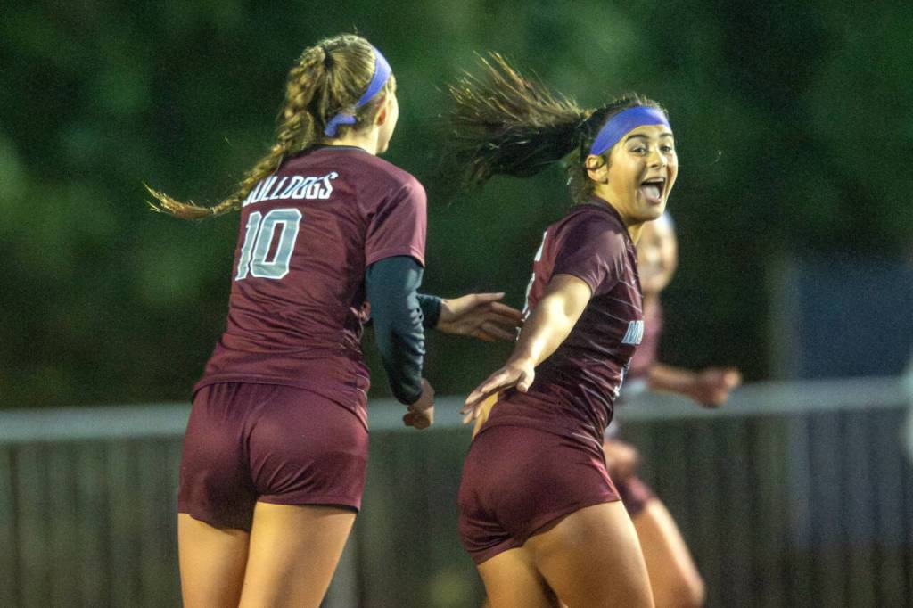 PHOTO BY FOREST WORGUM Montesano forward Jaelyn Butterfield, right, is congratulated by senior Mikayla Stanfield (10) during the Bulldogs 3-2 win over Seton Catholic in the 1A District 4 semifinals on Thursday in Montesano.