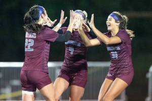 PHOTO BY FOREST WORGUM Montesanos Bethanie Henderson (22), Addi Kersker (4) and Jaelyn Butterfield (21) celebrate a goal by Henderson late in the Bulldogs 3-2 victory over Seton Catholic in the 1A District 4 semifinals on Thursday in Montesano.