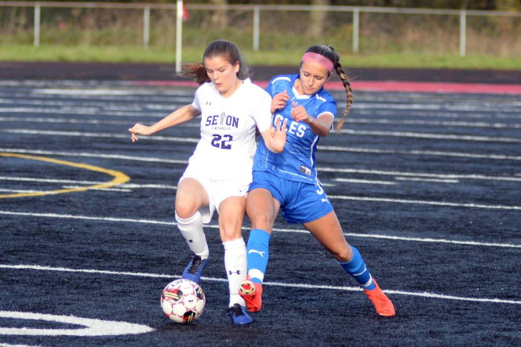RYAN SPARKS | THE DAILY WORLD Elma senior Mia Monroe, right, defends Seton Catholics Lydia Hawkinson during the 1A District 4 third-place game on Saturday at Tenino High School.