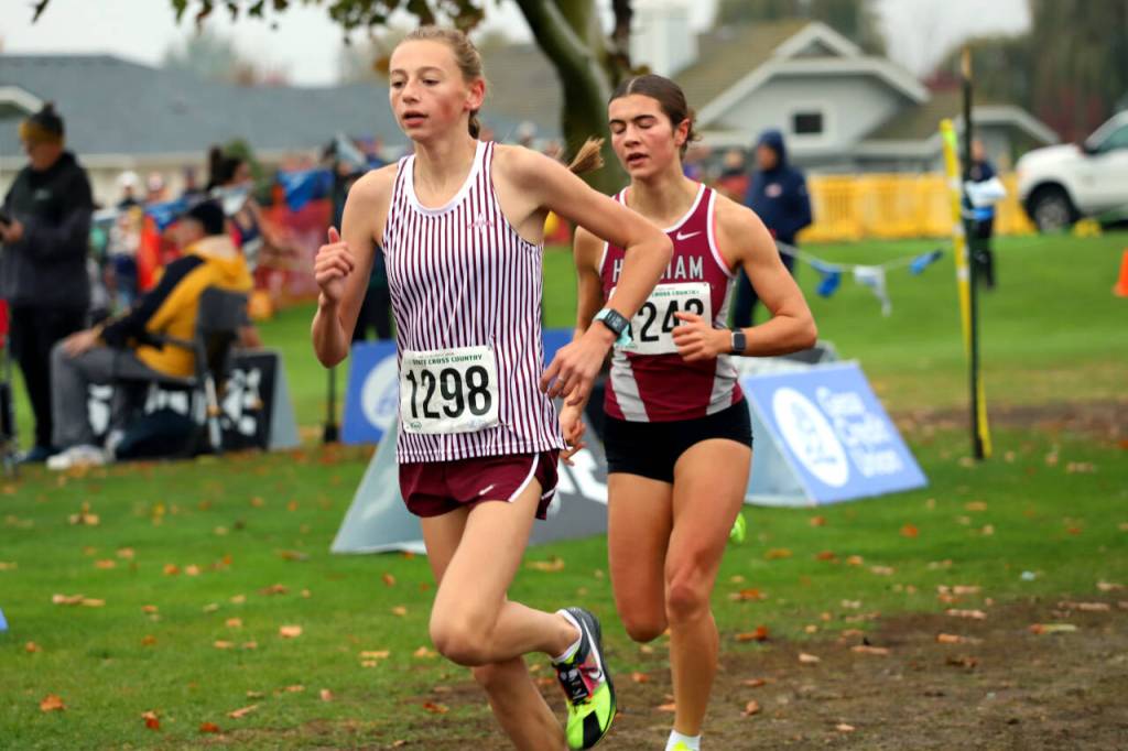 SUBMITTED PHOTO Hoquiams Jane Roloff, right, trails Montesanos Haley Schweppe during the first mile of the 1A State Championship girls cross-country race on Saturday at the Sun Willows Golf Course in Pasco.