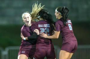PHOTO BY FOREST WORGUM Montesanos Kennedy Campbell, left, and Adda Potts (8) celebrate a goal by Bethanie Henderson (22) during the Bulldogs victory over Bellevue Christian in a 1A State first-round game on Wednesday in Montesano.