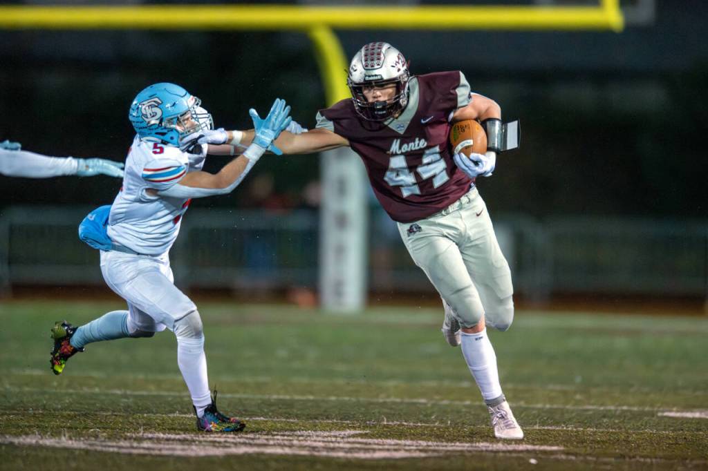 PHOTO BY FOREST WORGUM Montesano running back Gabe Bodwell (44) stiff arms Freeman linebacker Cody Cayce during a 28-21 loss in a 1A State first-round playoff game on Friday in Montesano.