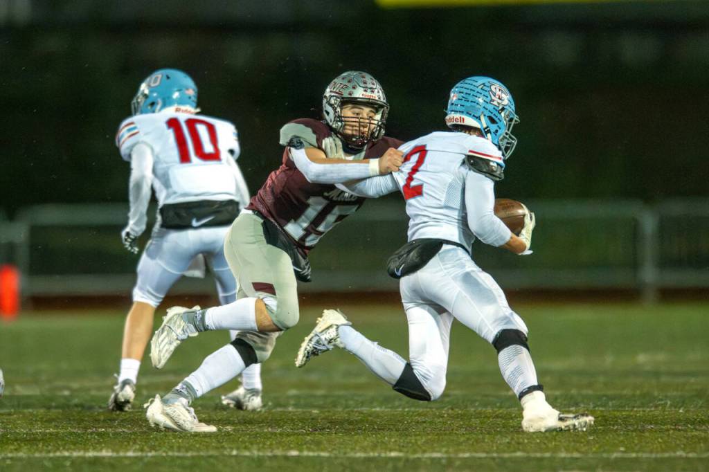 PHOTO BY FOREST WORGUM Montesano linebacker Felix Romero (15) tackles Freeman running back Kanoa Rogan during a 28-21 loss in a 1A State first-round playoff game on Friday in Montesano.