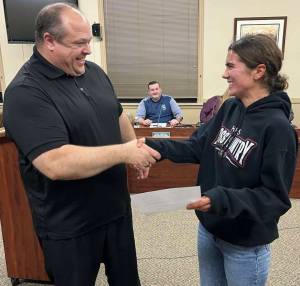Hoquiam City Council
Hoquiam Mayor Ben Winkelman, left, shakes Hoquiam High School senior Jane Roloffs hand after a city proclamation he read to honor the athlete during the Hoquiam City Council meeting on Monday. Dave Hinchen, Hoquiam city councilor, looks on with a smile, too.