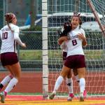 PHOTO BY FOREST WORGUM Montesanos Adda Potts (8) and Mikayla Stanfield (10) celebrate with Jaelyn Butterfield after she scored a goal in the first half of the Bulldogs 3-1 win over La Center in the 1A State third/fourth-place game on Saturday in Tacoma.