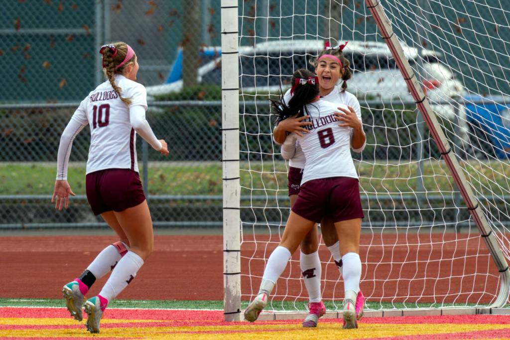 PHOTO BY FOREST WORGUM Montesanos Adda Potts (8) and Mikayla Stanfield (10) celebrate with Jaelyn Butterfield after she scored a goal in the first half of the Bulldogs 3-1 win over La Center in the 1A State third/fourth-place game on Saturday in Tacoma.