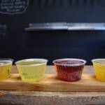 Matthew N. Wells / The Daily World
Four of Snowbird Farm and Ciderys hard apple ciders on a wooden flight board. From left, Apple Pie, Hoppy Opus, Elderberry Honey and Pumpkin Spice. There are four other ciders on tap as well at Snowbird and Raeann Edwards cant wait to show them off to any interested patrons.