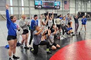 SUBMITTED PHOTO Grays Harbor College wrestlers cheer on a teammate during the Spokane Open on Sunday in Spokane.