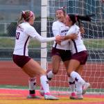 RYAN SPARKS | THE DAILY WORLD Montesanos Adda Potts, right, and Mikayla Stanfield, left, celebrate with Jaelyn Butterfield after she scored a goal in the first half of a 3-1 win over La Center in the 1A State third-place game on Saturday in Tacoma.