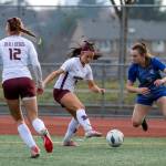 PHOTO BY FOREST WORGUM Montesano junior Adda Potts, middle, pressures La Center senior midfielder Shaela Bradley (5) during the Bulldogs 3-1 win in the 1A State third-place game on Saturday at Mount Tahoma Stadium in Tacoma.