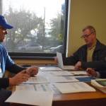 From left: Grays Harbor County Auditor Joe Maclean, Commissioner Kevin Pine and Deputy Prosecuting Attorney Jon Beltran examine and certify election results Tuesday afternoon. The three county officials were serving as up the Grays Harbor County Canvassing Board. (Clayton Franke / The Daily World)