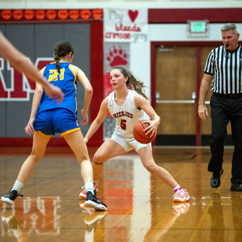PHOTO BY FOREST WORGUM Hoquiam guard Lexi LaBounty (5) dribbles against Rochesters Mandy Andree Cordell during a 45-18 season-opening loss on Tuesday at Hoquiam Square Garden.