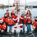 Santa arrives at Westports Santa by the Sea celebration during a past celebration via Coast Guard vessel at Float 6 in the Westport Marina before making his way to the museums lens hall to meet with the kids.