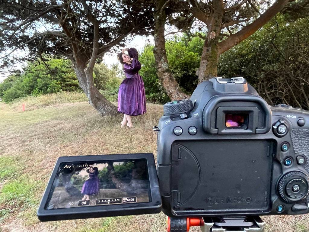 Jade Black, a fine art self-portrait photographer, poses in a marked spot during the last summer day in Ocean Shores. Black uses a camera with a single-point focus lens so she has to set everything up before she poses. This shoot was to show her Instagram followers part of her process. The finished product should look much more dramatic. (Matthew N. Wells / The Daily World)