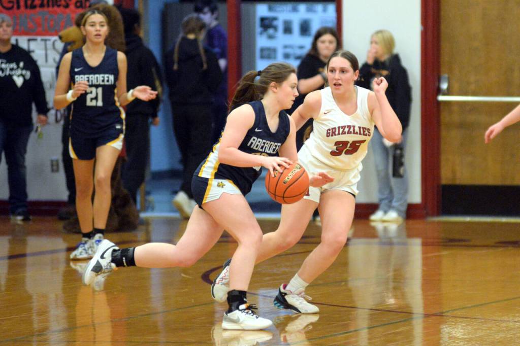RYAN SPARKS | THE DAILY WORLD Aberdeen freshman guard Bentley Btrown, left, dribbles against Hoquiams Dylan Little during the Bobcats 53-32 victory on Friday in Hoquiam.