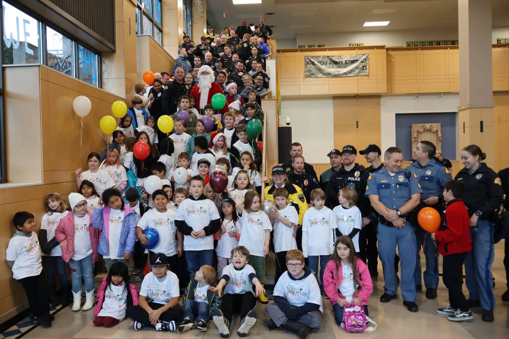 Michael S. Lockett / The Daily World
Police and children pose for a photo during the Shop with a Cop event on Saturday morning at Aberdeen High School.