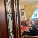 Clayton Franke / The Daily World
Charles Fattig, a McCleary history expert and member of the McCleary Historical Society, examines antique items in the home of longtime McCleary enthusiest John Anderson, who died in September at the age of 95. The wooden door with glass panels likely came from the Simpson Door Company factory, where Anderson worked for more than 40 years.