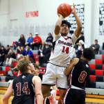 PHOTO BY LARRY BALE Raymonds Christopher Quintana (14) scores two of his team-high 21 points during a 52-42 win over Ocosta on Wednesday in Raymond.