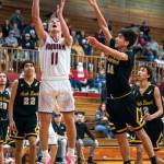 PHOTO BY FOREST WORGUM Hoquiam senior Zander Jump (11) puts up a shot against North Beachs Jeremiah Eastman during the Grizzlies 71-31 victory on Thursday at Hoquiam Square Garden.