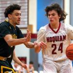 PHOTO BY FOREST WORGUM Hoquiam guard Lincoln Niemi (24) dribbles against North Beachs Tyrell Hovland during the Grizzlies 71-31 victory on Thursday at Hoquiam Square Garden.