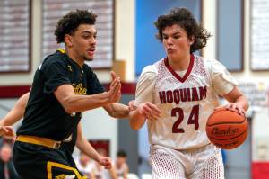 PHOTO BY FOREST WORGUM Hoquiam guard Lincoln Niemi (24) dribbles against North Beachs Tyrell Hovland during the Grizzlies 71-31 victory on Thursday at Hoquiam Square Garden.