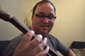 Clayton Franke / The Daily World
Matthew Wells, a reporter who has covered live music for The Daily World, plays an Alvarez acoustic guitar at Tinderbox Coffee Roasters in downtown Aberdeen on Monday, Dec. 11. Local musicians will throw a rock concert in his honor this Friday, Dec. 15.