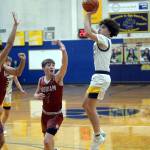 RYAN SPARKS | THE DAILY WORLD Aberdeen senior guard Manny Garcia, right, knocks down a jump shot over Hoquiam guard Joey Bozich during the Bobcats 55-49 overtime win on Monday in Aberdeen.