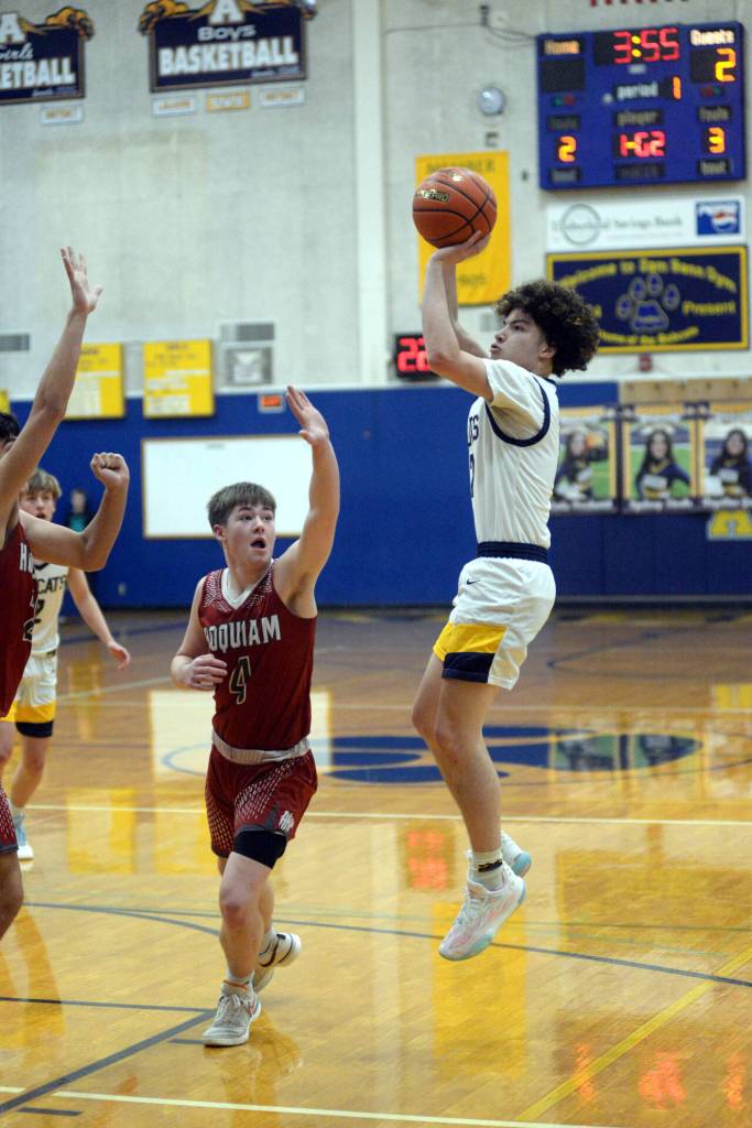 RYAN SPARKS | THE DAILY WORLD Aberdeen senior guard Manny Garcia, right, knocks down a jump shot over Hoquiam guard Joey Bozich during the Bobcats 55-49 overtime win on Monday in Aberdeen.
