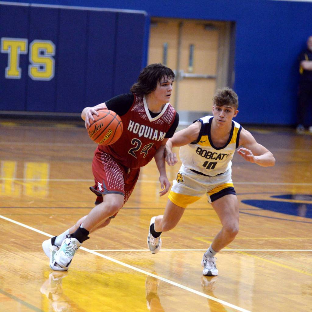 RYAN SPARKS | THE DAILY WORLD Aberdeen guard Grady Springer, right, defends against Hoquiam freshman Lincoln Niemi during the Bobcats 55-49 overtime win on Monday in Aberdeen.