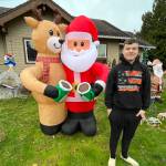 Matthew N. Wells / The Daily World
Put Bryson Walker on Santas nice list. Every year, just for the fun of it, Walker assembles an expansive Christmas light and decorative display at his familys home in Hoquiam  103 W. Eklund Ave. Clearly, Rudolph the Red Nosed Reindeer and Santa Claus approve as they clink their mugs full of hot cocoa.