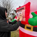 Matthew N. Wells / The Daily World
Bryson Walker updates his calendar that shows the number of days until Santa Claus and his eight reindeer show up in Hoquiam. Walker works for weeks on his familys elaborate display. He started helping out at 12, but since he turned 15, its mainly been his yearly project.