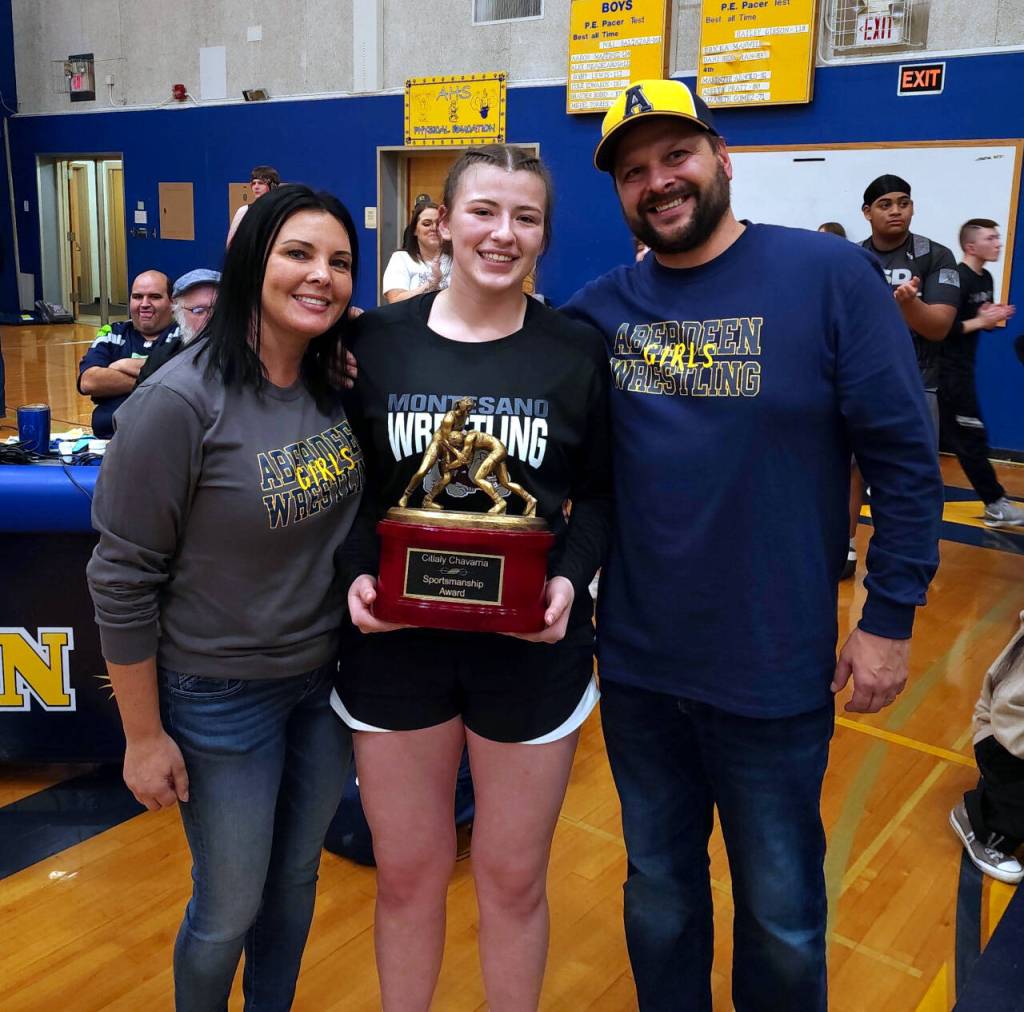 RYAN SPARKS | THE DAILY WORLD Montesanos Kya Roundtree, middle, is flanked by Aberdeen coaches Craig Yakovich, right, and Tamar Yakovich after being awarded with the Citlaly Chavarria Sportsmanship Award at the Grays Harbor Championships on Saturday in Aberdeen.