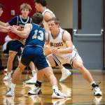 PHOTO BY FOREST WORGUM Montesanos Peyton Damasiewicz, right, defends against Cedar Park Christians Joey Fuiten (13) during the Bulldogs 54-41 victory on Monday at Montesano High School.