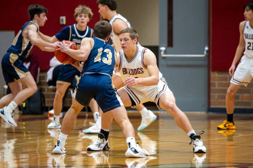 PHOTO BY FOREST WORGUM Montesanos Peyton Damasiewicz, right, defends against Cedar Park Christians Joey Fuiten (13) during the Bulldogs 54-41 victory on Monday at Montesano High School.