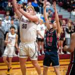 PHOTO BY FOREST WORGUM Montesanos Cam Taylor (50) scores from the low post against Black Hills Quinton Morrill during the Bulldogs 67-52 win in the Montesano Winter Classic on Friday in Montesano.