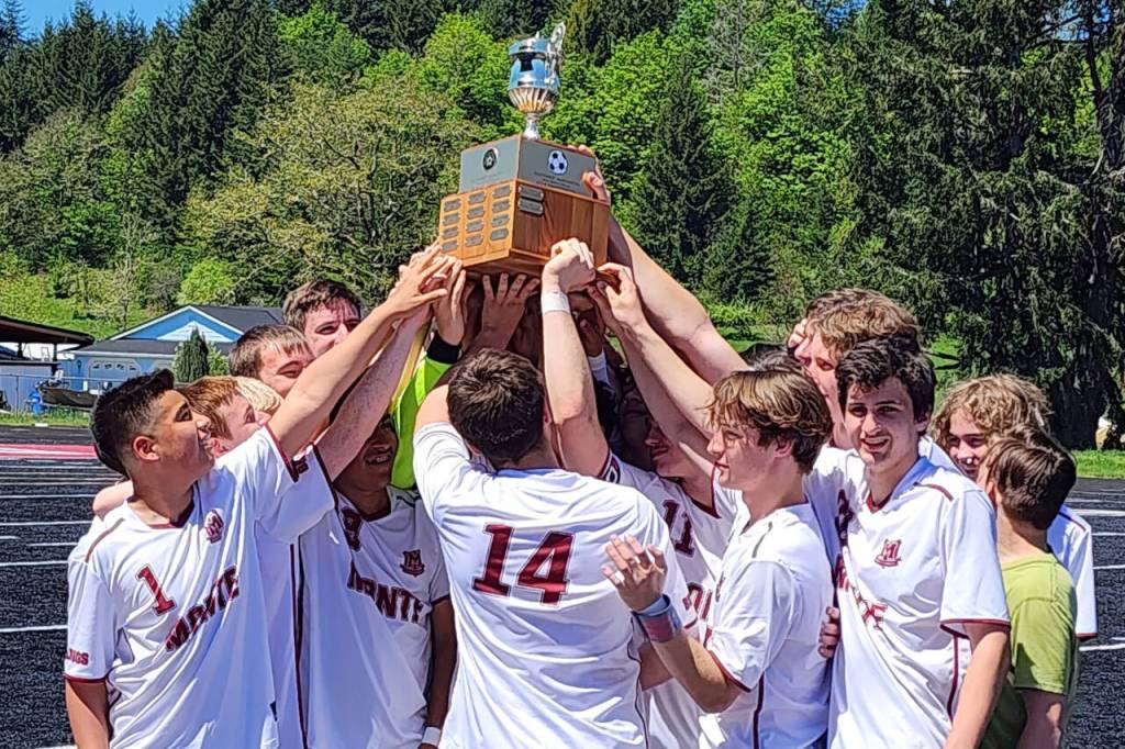 DAILY WORLD FILE PHOTO 
The Montesano boys soccer team raises its first ever district championship after defeating Seton Catholic in May.