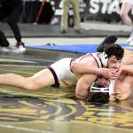 PHOTO BY SUE MICHALAK BUDSBERG 
Montesanos Mateo Sanchez, top, won a state title at the Mat Classic in February.