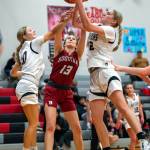 PHOTO BY FOREST WORGUM Raymond-South Bends Emma Glazier, left, and Kassie Koski, right, compete for a rebound against Hoquiams Katlyn Brodhead during the Ravens 49-17 win on Friday in Raymond.